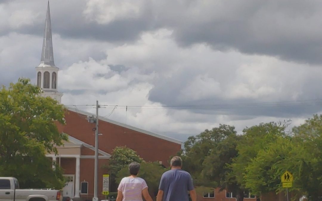 An image of Kristofer & Beth Cowles walking toward the Church